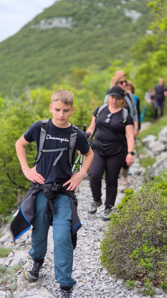 Young participants and hikers walking together on a mountain trail during the 12 Peaks – Challenge Up project on Velebit Mountain