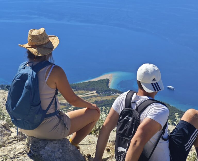 Participants of the 12 Peaks Challenge Up project on Vidova Gora, the highest peak of Brač Island, overlooking Zlatni Rat beach and the Adriatic Sea, Croatia.