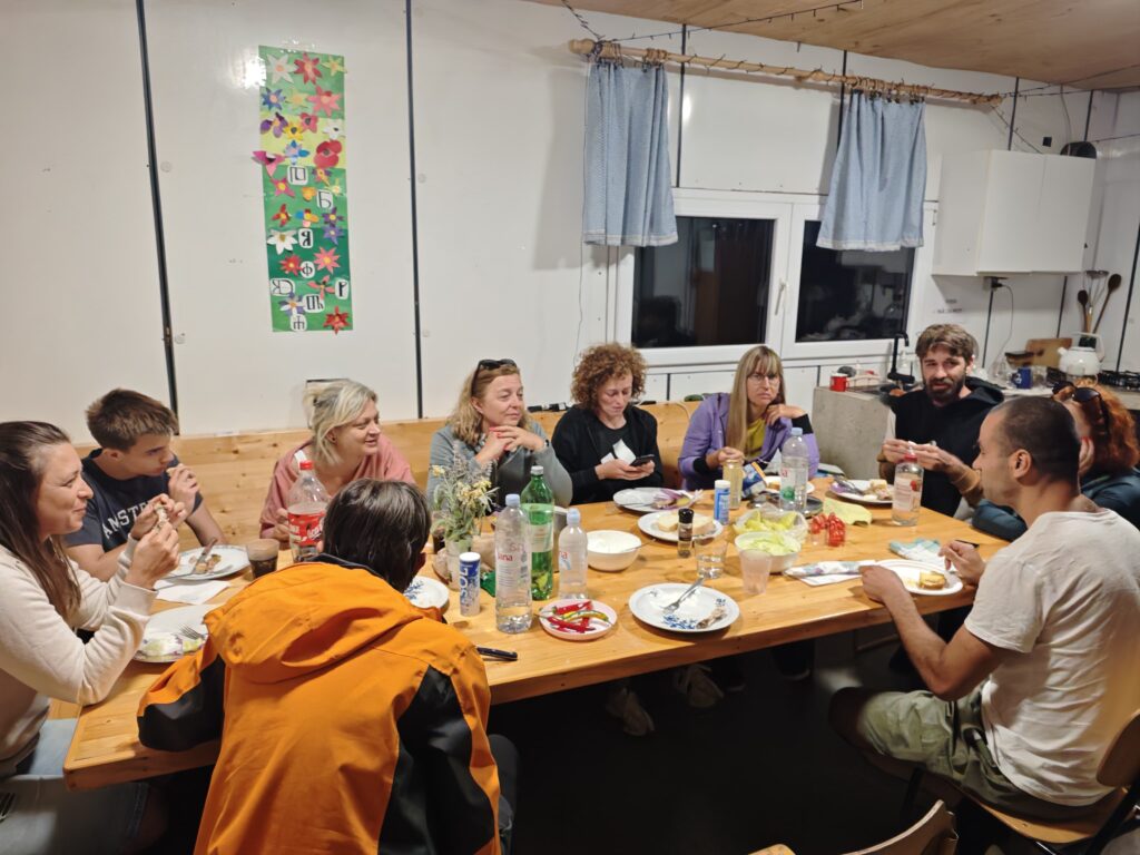 Members of the 12 Peaks Challenge Up project and Mountaineering Society Profunda sharing a meal at Gažul Mountain Hut on Brač Island.